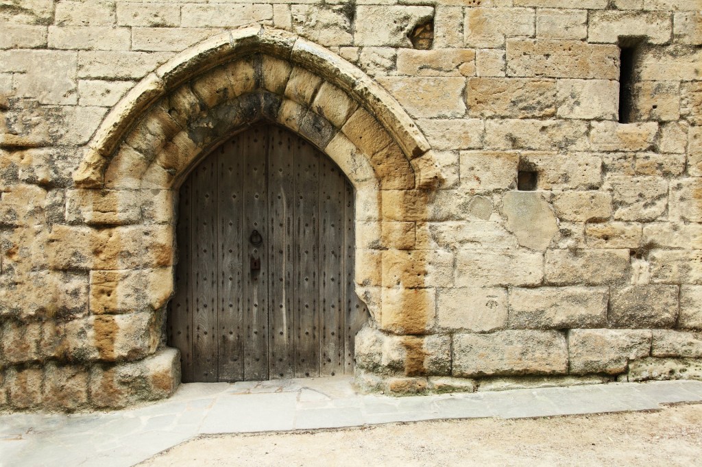 A castle stone wall with a door